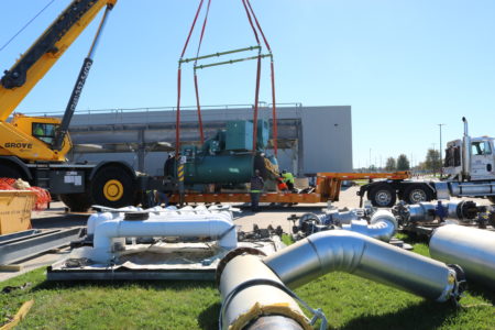 Machinery on a flatbed being placed into industrial storage