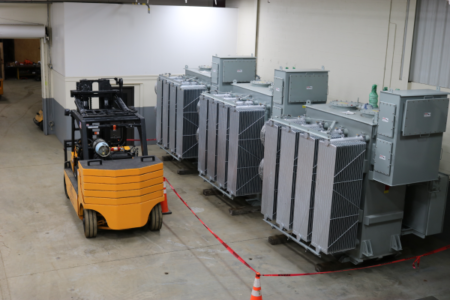 forklift by industrial equipment inside a warehouse