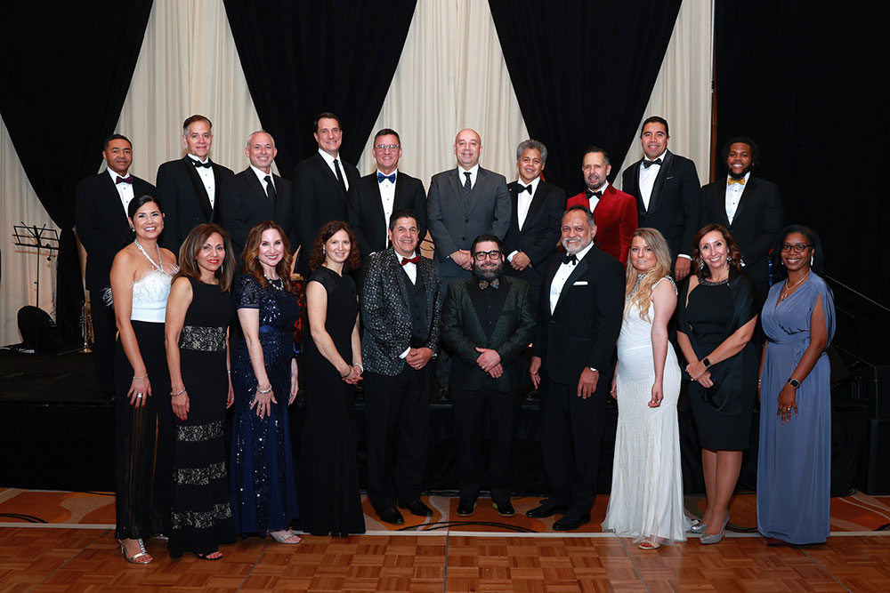 CCI Industrial Constructors - A group of elegantly dressed individuals posing together at a formal event.